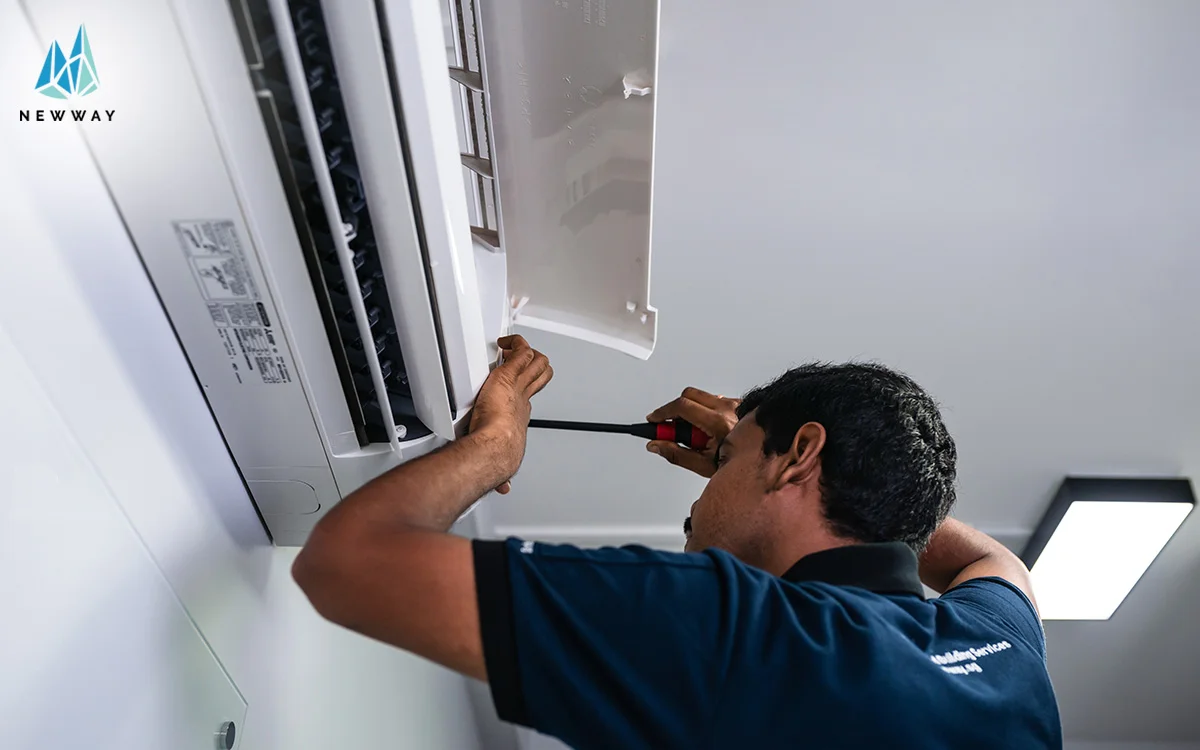 Repairman in the middle of a split ac installation.