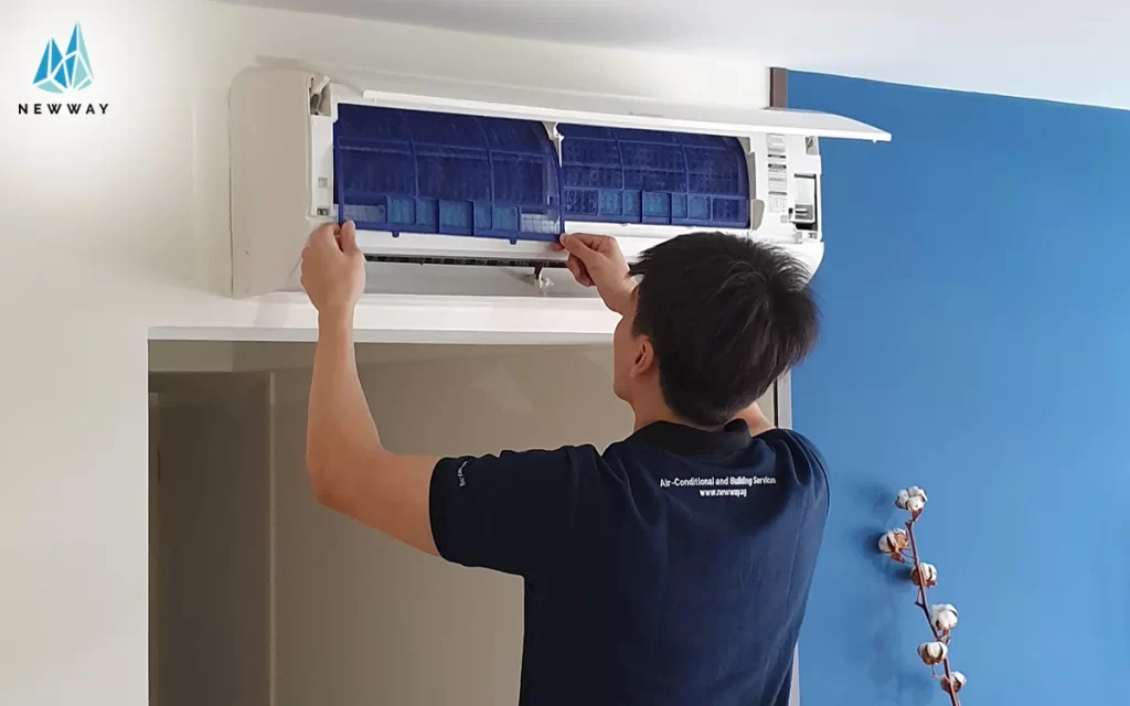 A man cleaning the aircon