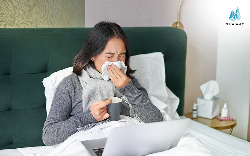 A sick woman rests in bed likely affected by poor indoor air quality