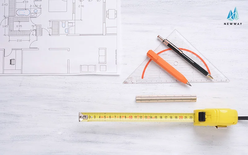 Coiled measuring tape with red markings on table.
