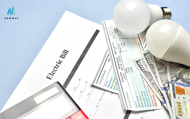 Electric bill with lightbulbs and money on desk.