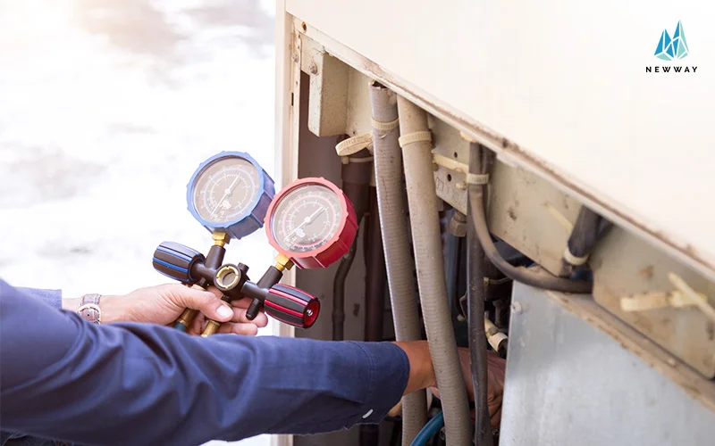 Technician checking aircon gas levels with gauge