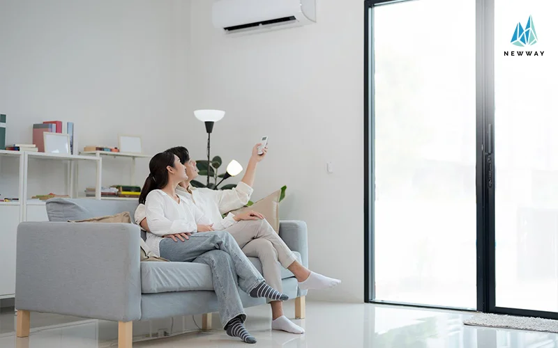 a couple turning on air conditioning in the living room