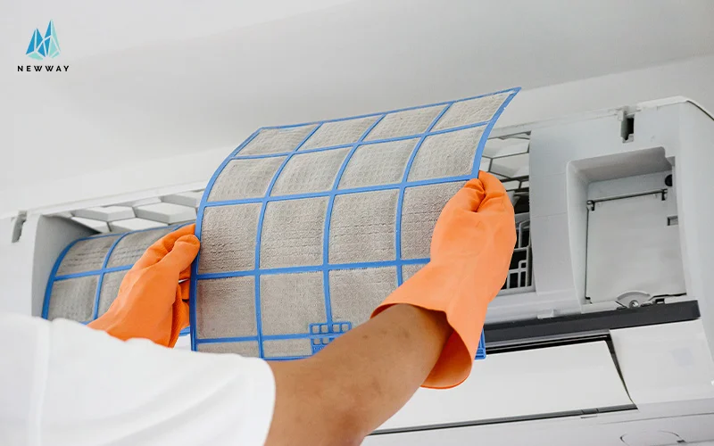 a technician replacing air conditioner filters