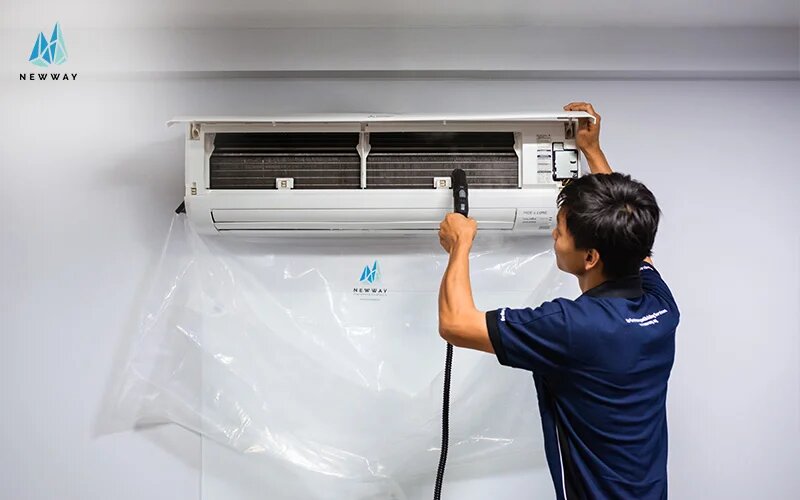 technician fixing aircon to prevent aircon overheating
