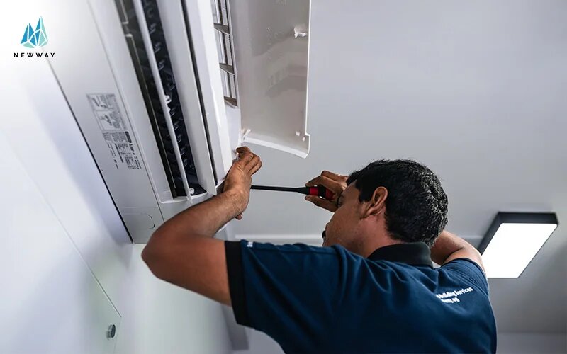 An aircon technician performing a landed property aircon installation.